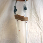 Long leg orthosis with metal uprights and straps