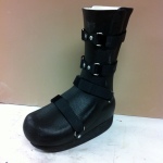 Black walking boot style orthosis with straps