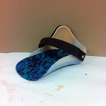Foot orthosis with patterned insole and strap